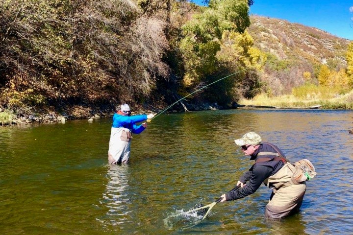 a man standing next to a body of water