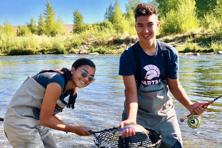 a person standing next to a body of water