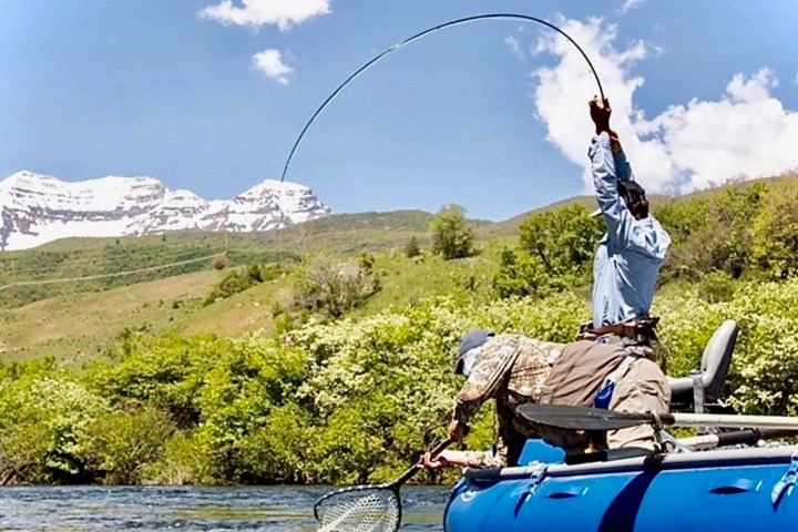 a man sitting on the side of a mountain