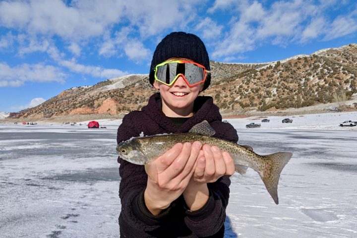 a person holding a fish in the water