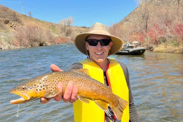 a man holding a fish in the water