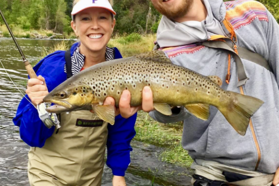 a person holding a fish